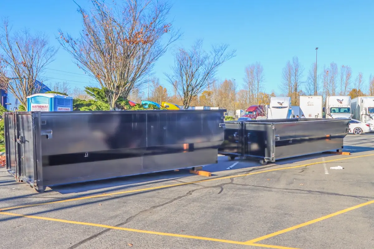 Professional dumpster rental service with roll-off container on residential driveway in Perkasie